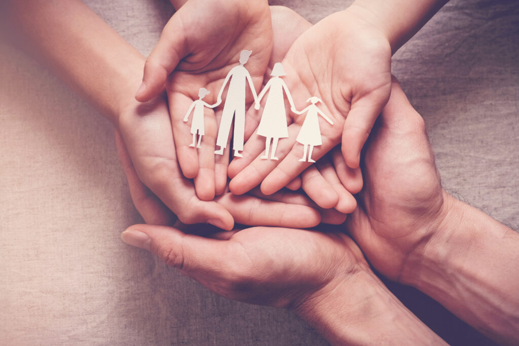 Hands,Holding,Paper,Family,Cutout,,Family,Home,,Foster,Care,,World